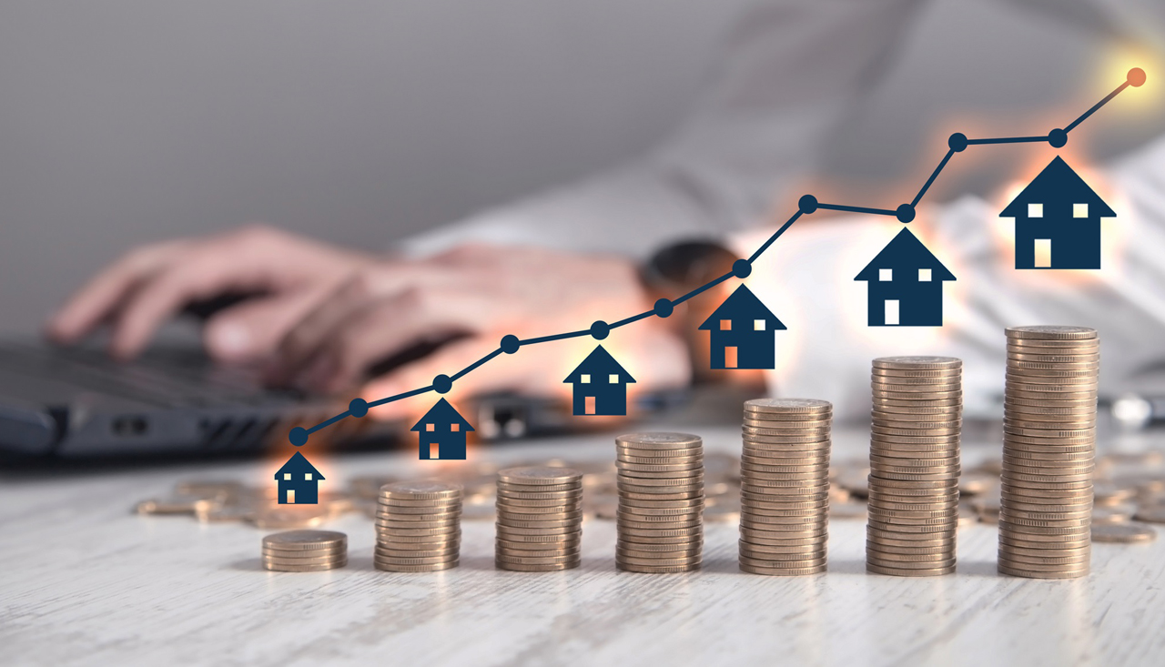 Real estate agent showing house and stack of coins. Real Estate