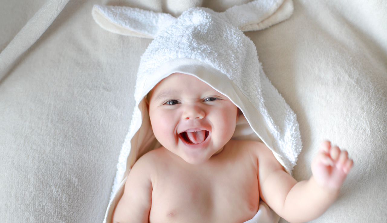 Adorable,Newborn,Baby,Wrap,By,White,Rabbit,Towel,With,Smiling